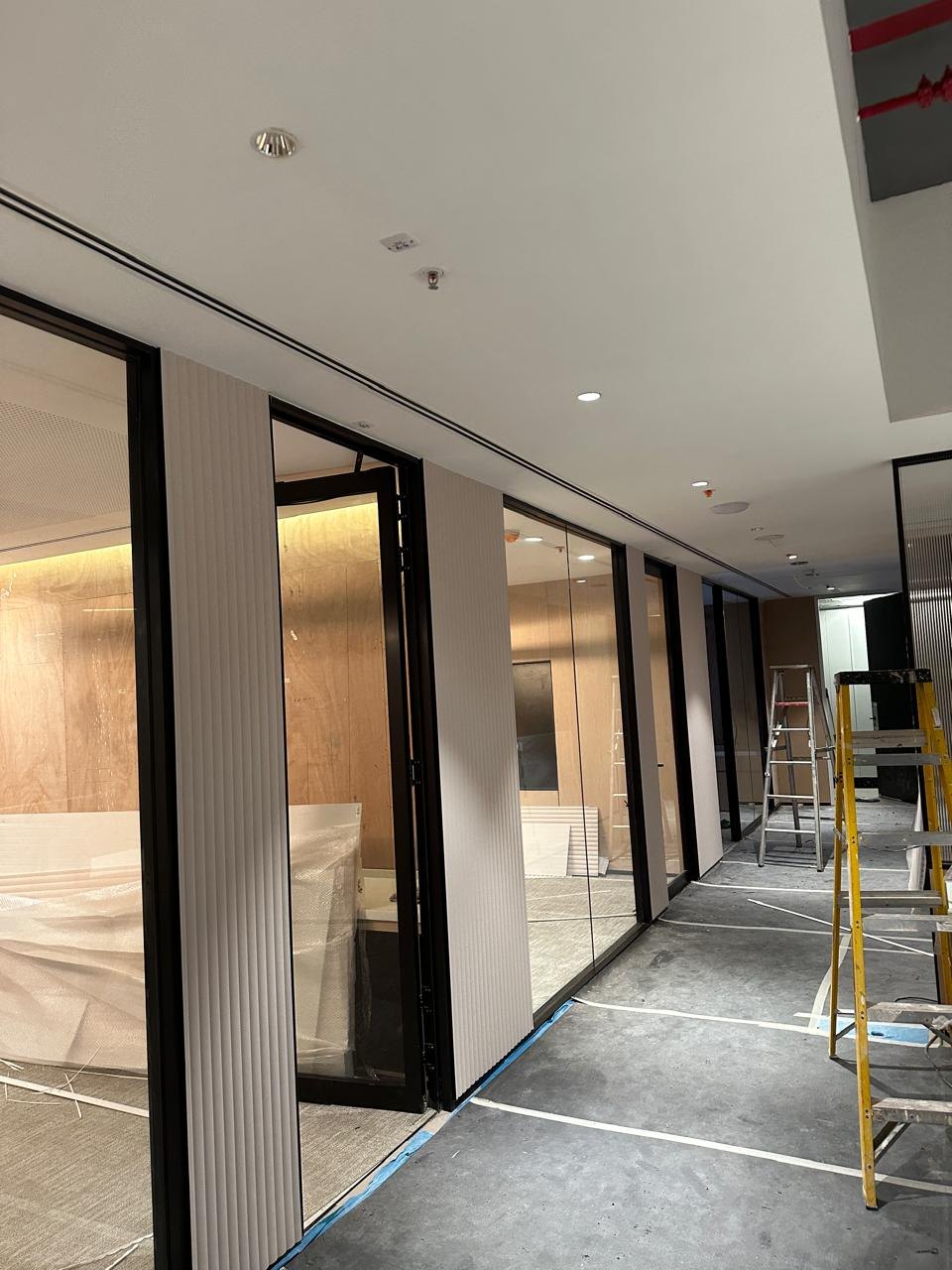 Fluted acoustic panelling running the length of a corridor