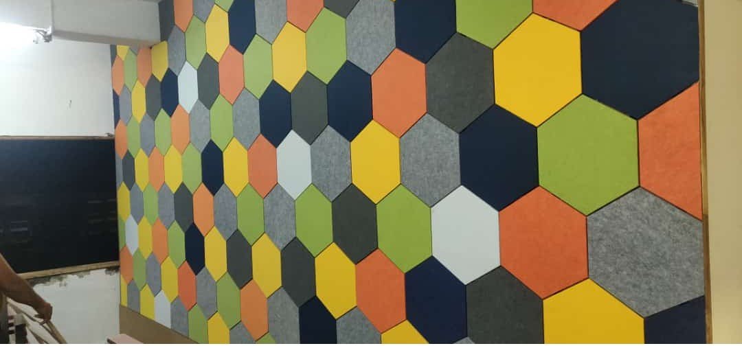 A full wall of multi-colour hexagon acoustic tiles