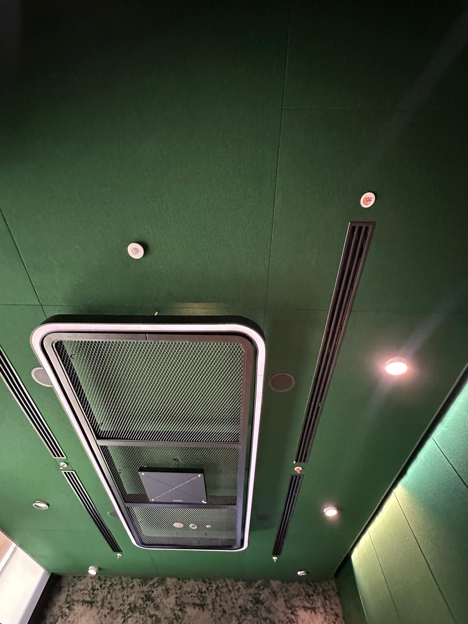 An acoustic ceiling treatment with recessed linear lighting